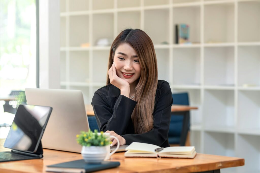 Beautiful Asian businesswoman sitting at the office using a laptop notebook place at the office.